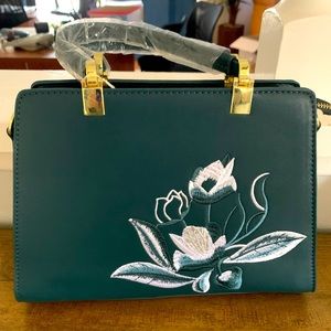 Green embroidered hand bag.